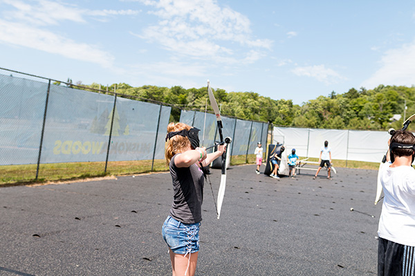 a girl playing archery tag